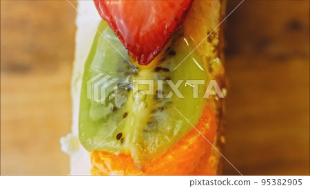 Fasting cake with tangerines, kiwi and strawberry. Macro and slider shooting Fasting cake with tangerines, kiwi and strawberry. Macro and slider shooting 95382905