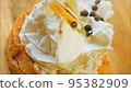 Coconut basket cake with white chocolate decorative leaves. Macro and slider shooting 95382909