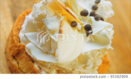 Coconut basket cake with white chocolate decorative leaves. Macro and slider shooting 95382909