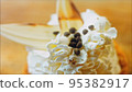 Coconut basket cake with white chocolate decorative leaves. Macro and slider shooting 95382917
