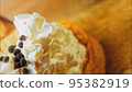 Coconut basket cake with white chocolate decorative leaves. Macro and slider shooting 95382919