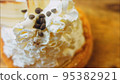 Coconut basket cake with white chocolate decorative leaves. Macro and slider shooting 95382921
