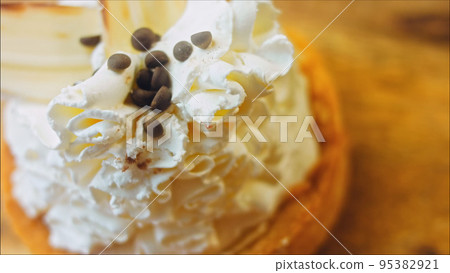 Coconut basket cake with white chocolate decorative leaves. Macro and slider shooting 95382921