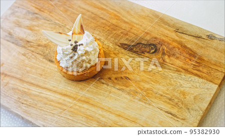 Coconut basket cake with white chocolate decorative leaves. Macro and slider shooting Coconut basket cake with white chocolate decorative leaves. Macro and slider shooting 95382930