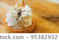 Coconut basket cake with white chocolate decorative leaves. Macro and slider shooting 95382932