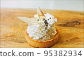 Coconut basket cake with white chocolate decorative leaves. Macro and slider shooting 95382934