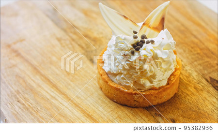 Coconut basket cake with white chocolate decorative leaves. Macro and slider shooting 95382936