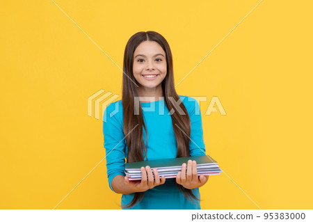 cheerful child girl hold notepad for homework, education cheerful child girl hold notepad for homework, education 95383000