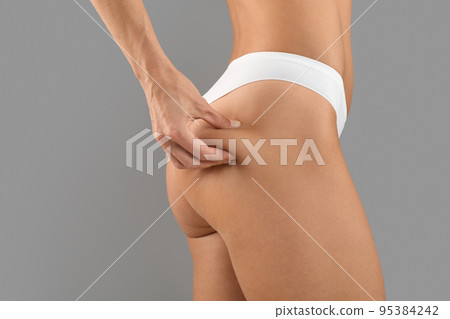 Anti Cellulite Massage. Young Slim Lady In Panties Pinching Skin On Buttocks 95384242
