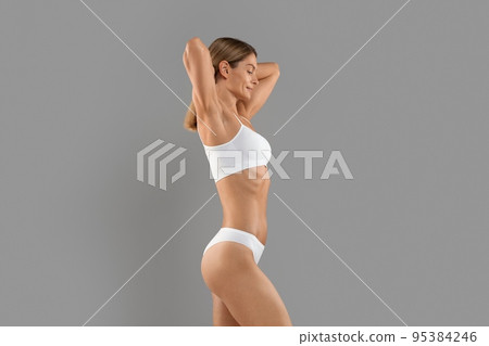 Body Sculpting. Side View Of Young Slim Female In White Underwear Body Sculpting. Side View Of Young Slim Female In White Underwear 95384246