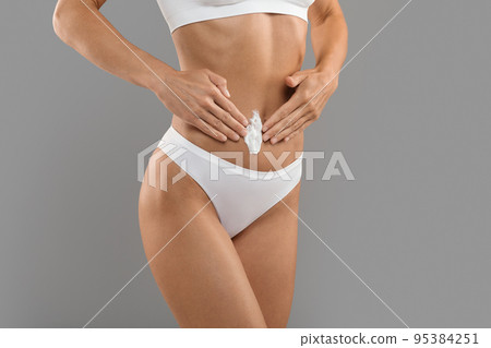 Body Care. Slim Sporty Woman Applying Moisturising Lotion On Belly Area Body Care. Slim Sporty Woman Applying Moisturising Lotion On Belly Area 95384251