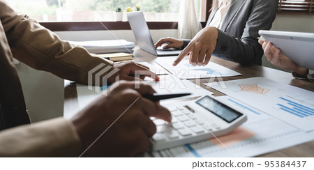 Business accounting team brainstorming data target financial on laptop calculator and paperwork Business accounting team brainstorming data target financial on laptop calculator and paperwork 95384437