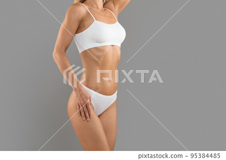 Body Sculpting. Cropped Shot Of Athletic Young Woman In White Underwear Body Sculpting. Cropped Shot Of Athletic Young Woman In White Underwear 95384485