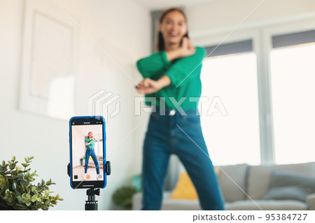 Female Blogger Dancing Making Video For Blog Indoors, Selective Focus Female Blogger Dancing Making Video For Blog Indoors, Selective Focus 95384727
