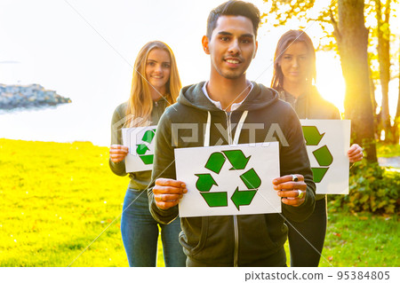 Environmental protection team holding recycling symbol placards Environmental protection team holding recycling symbol placards 95384805