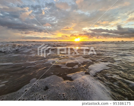 Sunset over ocean waves Sunset over ocean waves 95386175
