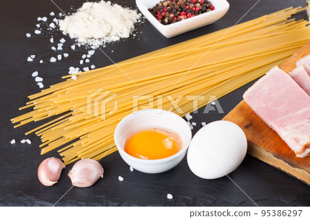 Ingredients for Pasta Carbonara on black slate background Ingredients for Pasta Carbonara on black slate background 95386297