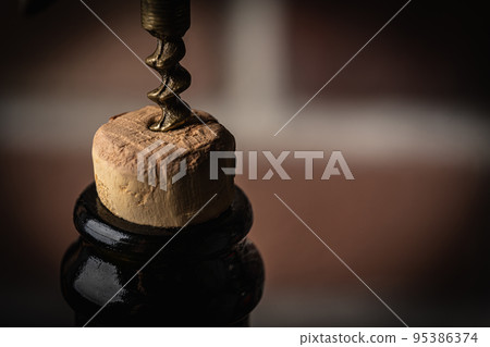 Bottle of wine with corkscrew 95386374