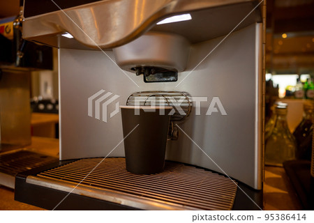 Black Paper Cup Is In Coffee Machine. Concept Of Self-Service In Cafes And Gas Stations. 95386414