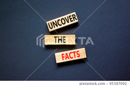 Uncover the facts symbol. Concept words Uncover the facts on wooden blocks on a beautiful black table black background. Business and uncover the facts concept. Copy space. 95387092
