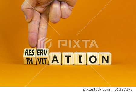 Invitation or reservation symbol. Businessman turns cubes and changes the concept word Invitation to Reservation. Beautiful orange background. Business Invitation or reservation concept. Copy space. 95387173