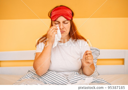 Female sitting on bed thinking depressed, feeling bad. Young woman suffering from depression, loneliness and stress at home  95387185