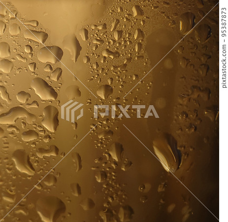 Condensation droplets on a transparent glass surface close-up 95387873