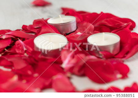 Rose petals and scented candles on the floor. 95388051