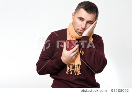 A handsome man touches his mouth with his hand with a pained expression because of toothache or tooth disease, dentist concept. 95388062