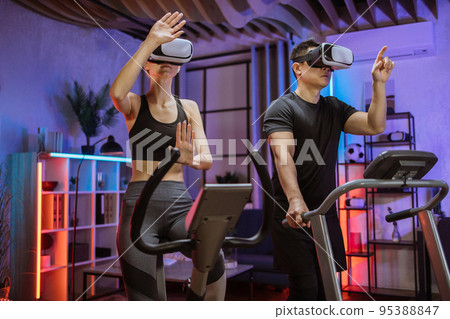 Cardio training, exercise machines, exercising legs, cardio workout indoors, 3D reality concept Cardio training, exercise machines, exercising legs, cardio workout indoors, 3D reality concept 95388847