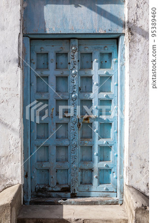 Antique old wooden door. Beautiful colour. Bright sunny day.  95389460