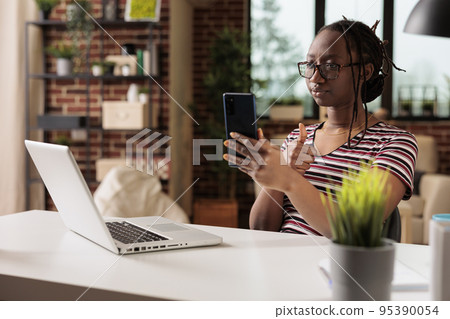 Freelancer showing appreciation gesture on smartphone videocall, woman working from home. Employee with thumb up attending virtual meeting, remote worker chatting on teleconference Freelancer showing appreciation gesture on smartphone videocall, woman working from home. Employee with thumb up attending virtual meeting, remote worker chatting on teleconference 95390054