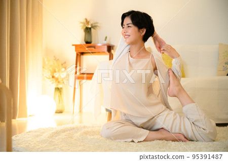 woman doing yoga before bed 95391487