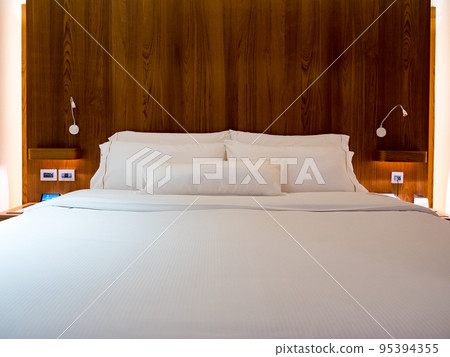Clean Bedding sheets and pillow on natural wall room background. Clean Bedding sheets and pillow on natural wall room background. 95394355