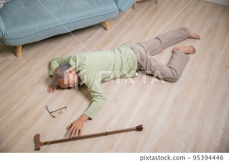 Sick senior old man falling down lying on floor because stumbled at home 95394446