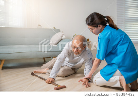 Disabled elderly man patient with walking stick fall on ground and caring assistant Disabled elderly man patient with walking stick fall on ground and caring assistant 95394452