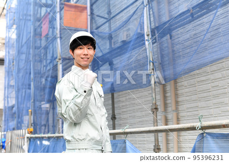 Young male worker working at a construction site Young male worker working at a construction site 95396231