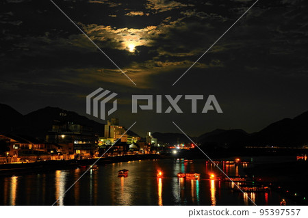 Cormorant fishing on the Nagara River and the moon between clouds Cormorant fishing on the Nagara River and the moon between clouds 95397557