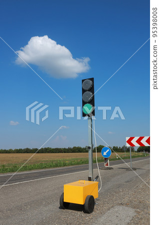 Green traffic light and road works Green traffic light and road works 95398008