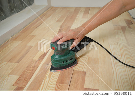 Home renovation, worker sanding wooden stairs or floor Home renovation, worker sanding wooden stairs or floor 95398011