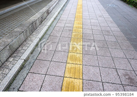 After the rain, the town, the tactile blocks and the sidewalk in a light rain After the rain, the town, the tactile blocks and the sidewalk in a light rain 95398184