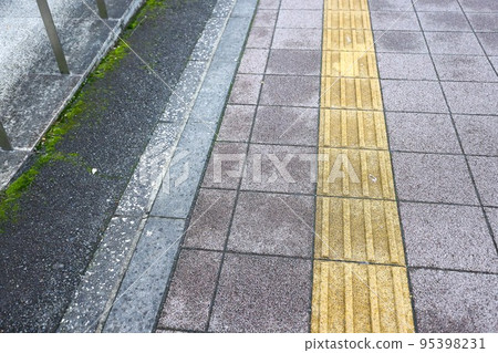 After the rain, the town, the tactile blocks and the sidewalk in a light rain After the rain, the town, the tactile blocks and the sidewalk in a light rain 95398231
