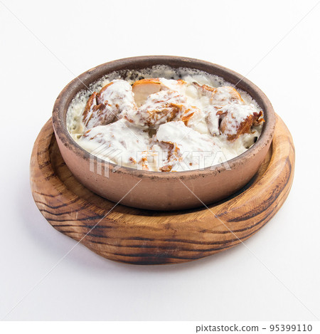 A beautiful shot of a bowl of chmeruli A beautiful shot of a bowl of chmeruli 95399110