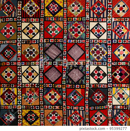 A closeup shot of national ornaments and patterns of Central Asia on fabric 95399277