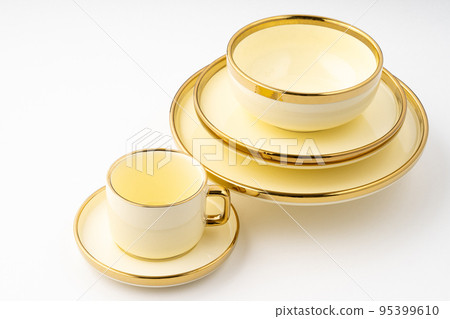 A set of golden luxury ceramic kitchen utensils on a white background A set of golden luxury ceramic kitchen utensils on a white background 95399610