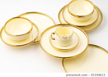 A set of golden luxury ceramic kitchen utensils on a white background A set of golden luxury ceramic kitchen utensils on a white background 95399612