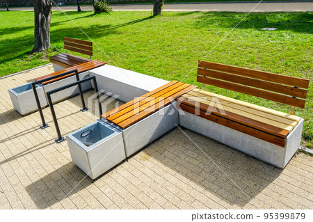 New modern design outdoor infrastructure object, wooden plank rest benches with a concrete base New modern design outdoor infrastructure object, wooden plank rest benches with a concrete base 95399879