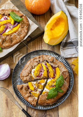 Homemade galette pie or crostata with pumpkin and ricotta cheese on rustic  background. Thanksgiving day food. 95400208