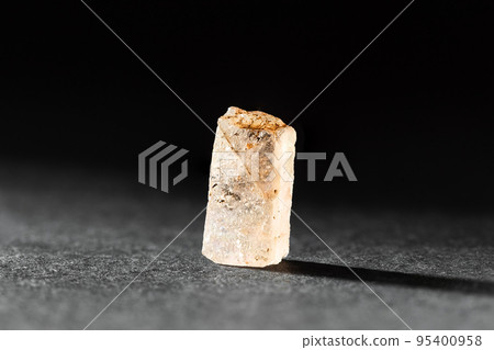 Rough uncut Yellow Topaz stone sample on black 95400958