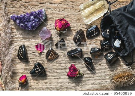 Set of different crystals and rune stones on wood 95400959